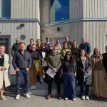 Group photo from the visit to TVT Asunnot Oys Hirvensalo comparison project together with Kati Leppiaho. The site presented a project comparing the environmental impacts, energy efficiency, and living experience of wooden and concrete apartment buildings ,Niina Fu