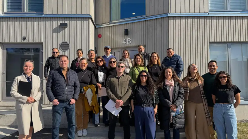 Group photo from the visit to TVT Asunnot Oys Hirvensalo comparison project together with Kati Leppiaho. The site presented a project comparing the environmental impacts, energy efficiency, and living experience of wooden and concrete apartment buildings ,Niina Fu